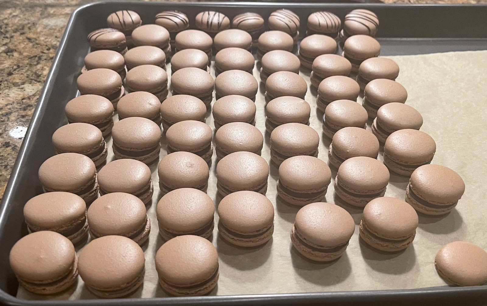 A tray of chocolate macarons